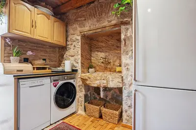 a kitchen with a washer and dryer next to a refrigerator at Olvion House in Athens