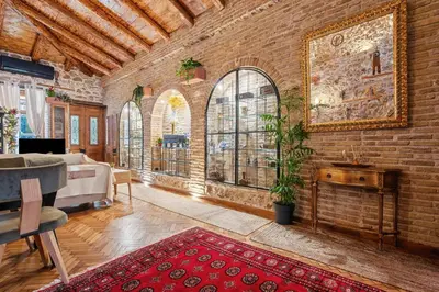 a living room with a brick wall at Olvion House in Athens