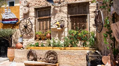 a building with a window with potted plants on it at Olvion House in Athens