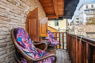 a pair of chairs sitting on a balcony at Olvion House in Athens