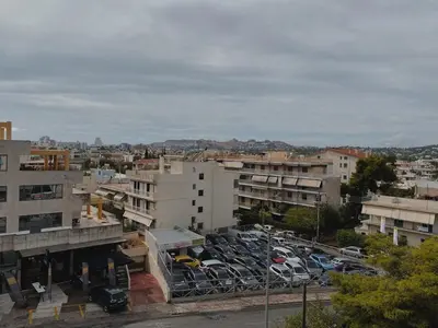 a parking lot full of parked cars in a city at Einstein Apartment in Athens