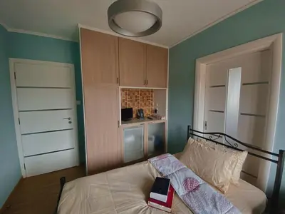 a bedroom with a bed with a book on it at Einstein Apartment in Athens