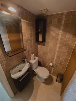 a bathroom with a white toilet and a sink at Einstein Apartment in Athens