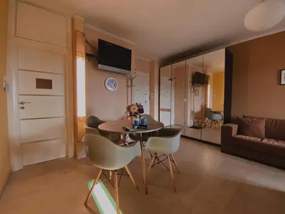 a living room with a table and chairs and a couch at Einstein Apartment in Athens