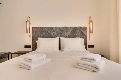 a bedroom with a bed with towels on it at Athens Marbles-Classic suite in Athens