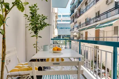 a balcony with a table and chairs on a balcony at Athens Marbles-Classic suite in Athens