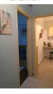 an open door to a room with a kitchen at BUDGET FLAT , 10 min from Victoria square in Athens