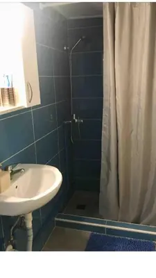 a bathroom with a sink and a shower with a shower curtain at BUDGET FLAT , 10 min from Victoria square in Athens
