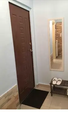 a room with a brown door with a mirror and a bench at BUDGET FLAT , 10 min from Victoria square in Athens
