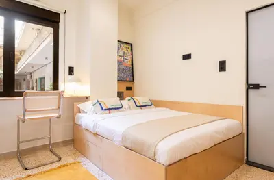 a bedroom with a bed and a chair in it at The Athenette in Athens