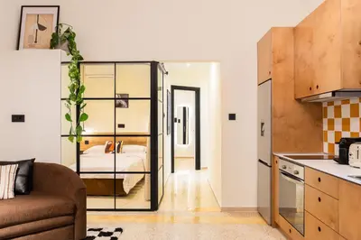 a living room with a couch and a bedroom at The Athenette in Athens