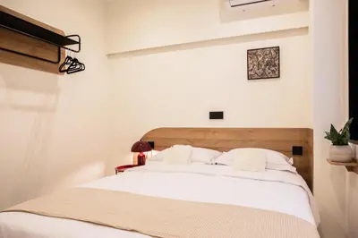 a bedroom with a large bed with white sheets at The Athenette in Athens