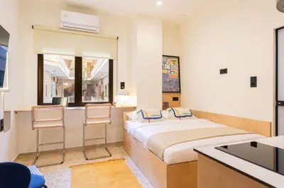 a bedroom with a large bed and two chairs at The Athenette in Athens
