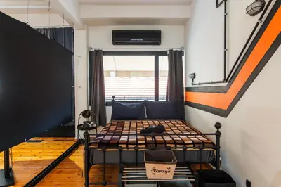 a small room with a bed and a window at Athena's Forge in Athens