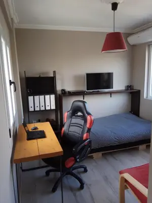 a bedroom with a desk and a chair and a bed at Rooftop cozy loft in Athens