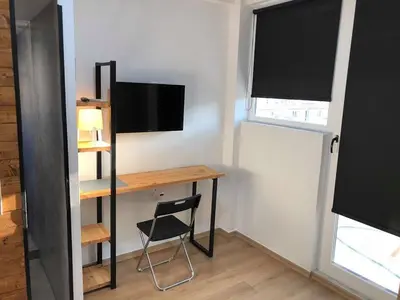 a small room with a desk and a television at Athens downtown rooftop loft #2 in Athens