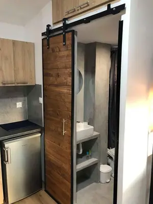 a bathroom with a door leading to a sink at Athens downtown rooftop loft #2 in Athens