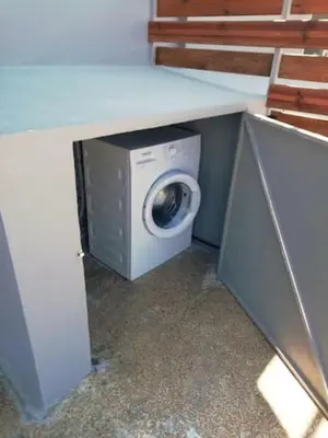 a washing machine and a washer under a counter at Athens downtown rooftop loft #2 in Athens