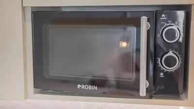 a microwave oven with a door open in a kitchen at Central Luxurious Athens Suites- walk to Acropolis - by Good Life suites in Athens