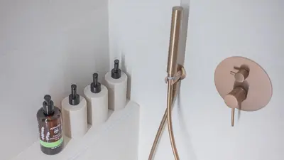 a wall with four toilet paper dispensers on a wall at Central Luxurious Athens Suites- walk to Acropolis - by Good Life suites in Athens