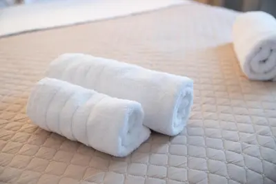 two rolls of toilet paper on a bed at Niki Athens Suites - Urban Suite at Historical Centre Monastiraki in Athens