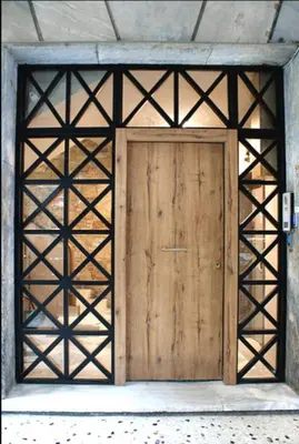 an open wooden door in a building at Niki Athens Suites - Urban Suite at Historical Centre Monastiraki in Athens