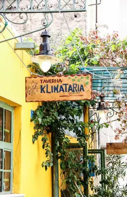 a street sign on a building with a street light at Niki Athens Suites - Urban Suite at Historical Centre Monastiraki in Athens
