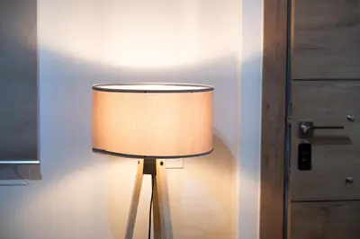 a lamp in a room next to a door at Niki Athens Suites - Cosy Suite at Historical Centre Monastiraki in Athens