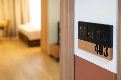 a sign on the door of a hotel room at Niki Athens Suites - Cosy Suite at Historical Centre Monastiraki in Athens