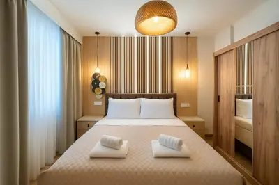 a bedroom with a bed with two white pillows on it at Niki Athens Suites - Cosy Suite at Historical Centre Monastiraki in Athens