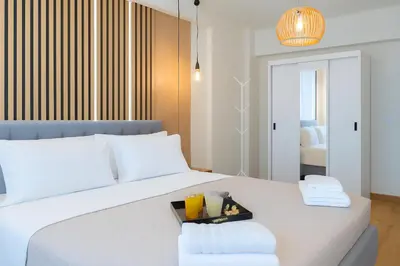 a bedroom with a white bed with a tray on it at Niki Athens Suites - Deluxe Suite at Historical Centre Monastiraki in Athens