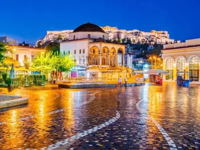a city street in the rain at night at Niki Athens Suites - Deluxe Suite at Historical Centre Monastiraki in Athens