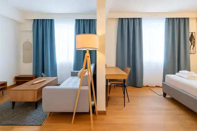 a living room with a couch and a table at Niki Athens Suites - Deluxe Suite at Historical Centre Monastiraki in Athens