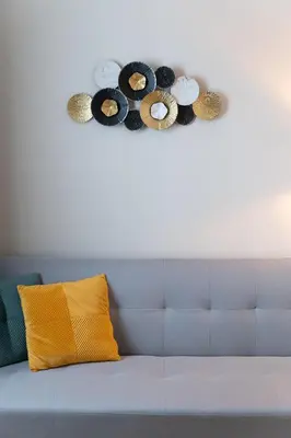 a blue couch with a yellow pillow and a white wall at Niki Athens Suites - Deluxe Suite at Historical Centre Monastiraki in Athens
