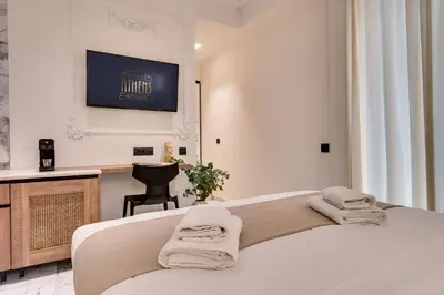 a bedroom with a bed with towels on it at Athens Marble - Intimate studio in Athens