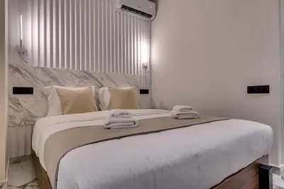 a bedroom with a large bed with towels on it at Athens Marble - Intimate studio in Athens