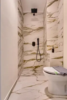 a bathroom with a toilet and a shower at Athens Marble - Intimate studio in Athens