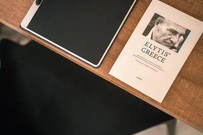 a book sitting on top of a wooden table at Athens Marble - Intimate studio in Athens