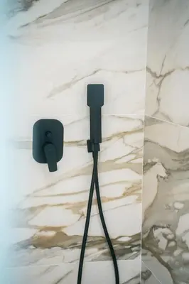 a pair of audio speakers on a wall with marble at Athens Marble - Intimate studio in Athens