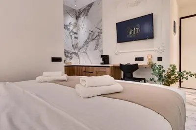 a bedroom with two beds with white towels on them at Athens Marble - Intimate studio in Athens