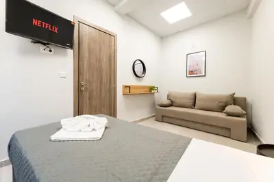 a bedroom with a bed and a couch at Zeus 2bd 2' minutes walk from Larissa's station in Athens