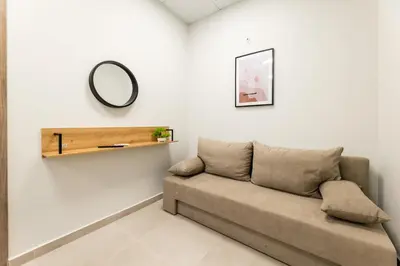 a living room with a couch and a mirror at Zeus 2bd 2' minutes walk from Larissa's station in Athens
