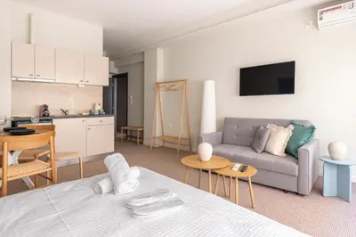 a living room with a couch and a kitchen at Zen Ermou City Center 1 in Athens