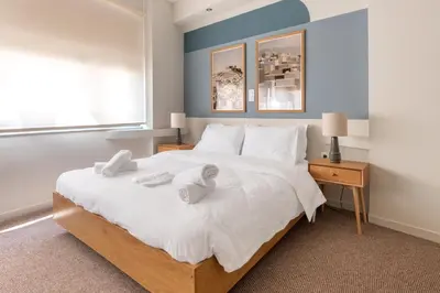 a bedroom with a large bed with towels on it at Zen Ermou City Center 1 in Athens