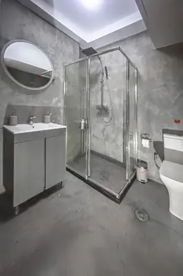 a bathroom with a shower and a sink and a toilet at Zen Ermou City Center 1 in Athens