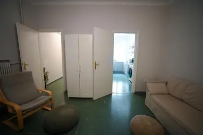a living room with a couch and a chair at Athenian Suite Klathmonos by Zeus Suites in Athens