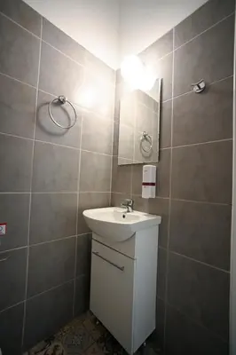 a bathroom with a sink and a mirror at Athenian Suite Klathmonos by Zeus Suites in Athens