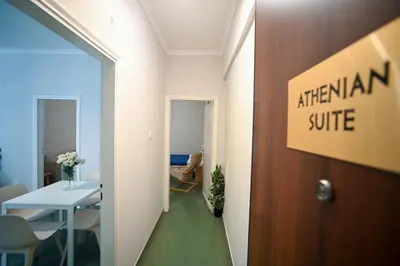 an office with a hallway with a table and a door at Athenian Suite Klathmonos by Zeus Suites in Athens