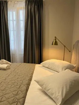 a bedroom with two beds and a window at Aura Suite Stadiou by Zeus Suites in Athens