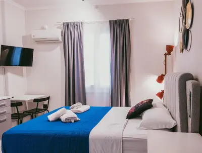 a hotel room with a bed with towels on it at Aura Suite Stadiou by Zeus Suites in Athens